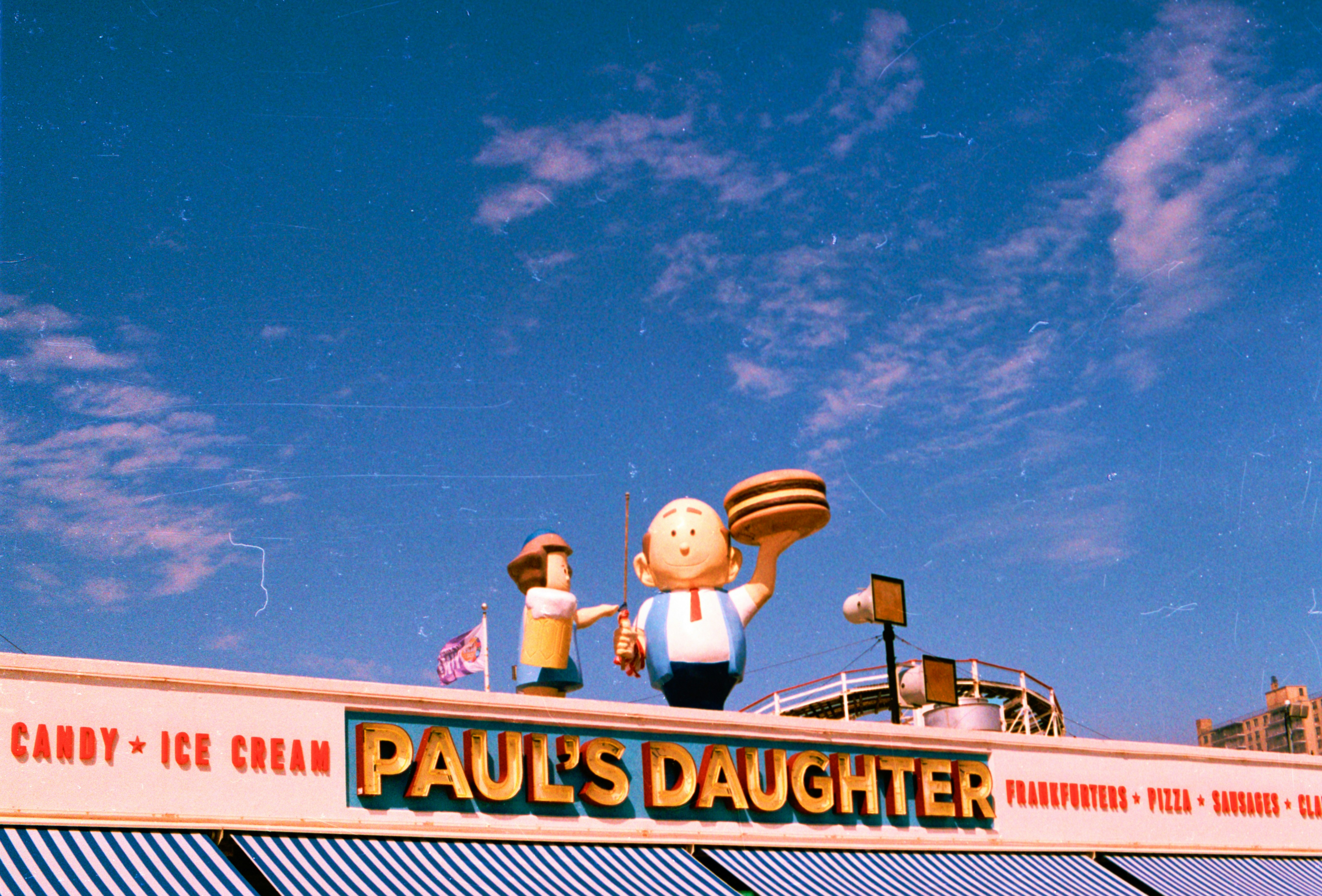 Paul's daughter restaurant sign with figures.